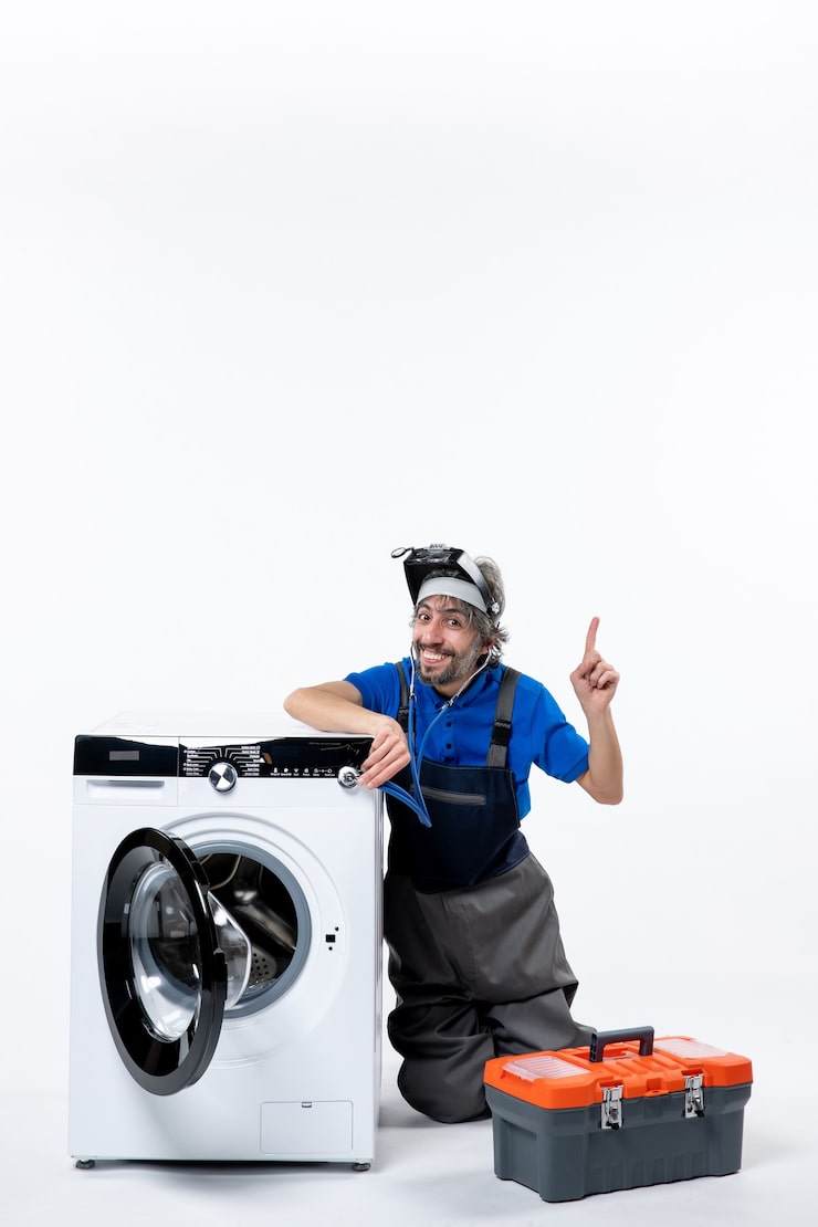 front view elated repairman sitting near washing machine raising his hand white space 140725 106443.jpg